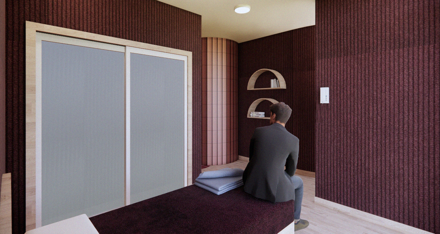 Patient room with all built in furniture and a polycarbonate wardrobe door, fitted with fabric upholstered walls. Burgundy/warm red